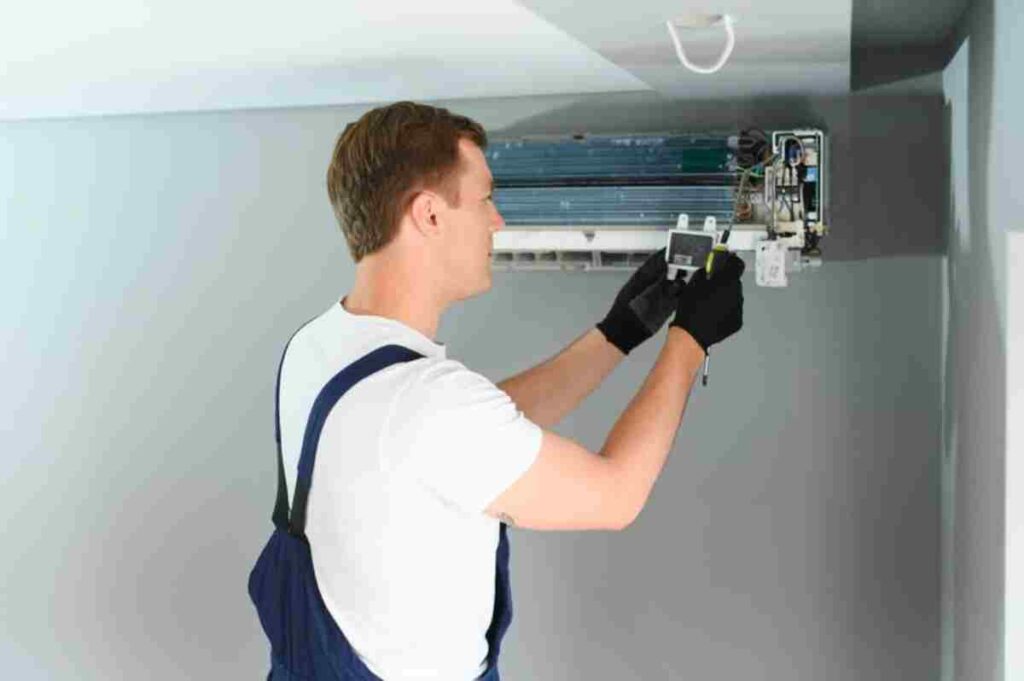 Technician repairing and installing an air conditioning unit.